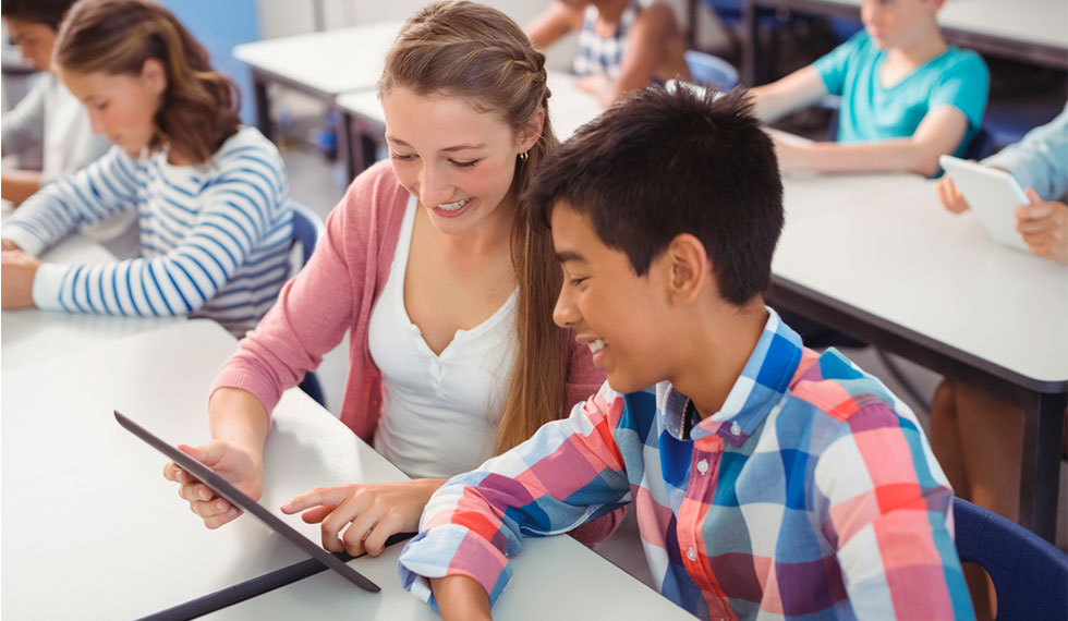 Students take a progress test in the classroom through an e-learning platform